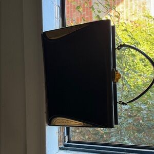 Elegant Black Prestige Destination Handbag with Gold Accents Rome Paris London